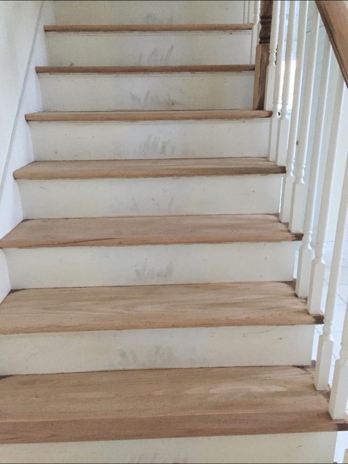 Stair frame with bare treads before refinishing