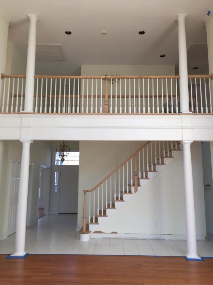 Interior staircase and balcony with white trim